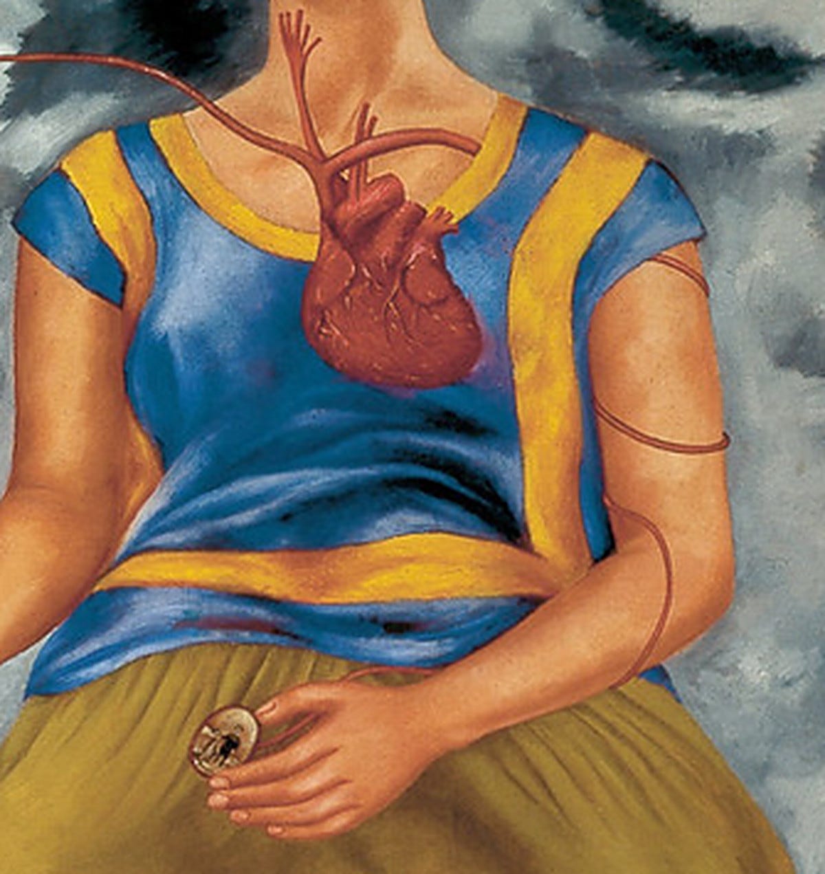 Close view of the Tehuana costume, a blue short sleeve blouse with yellow bands worn over a long olive skirt. Close view of the Tehuana costume, a blue short sleeve blouse with yellow bands worn over a long olive skirt.