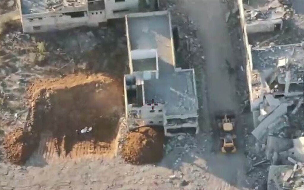 Hamas operatives are seen staging the recovery of the remains of a hostage in Gaza City, October 27, 2025. (Courtesy)