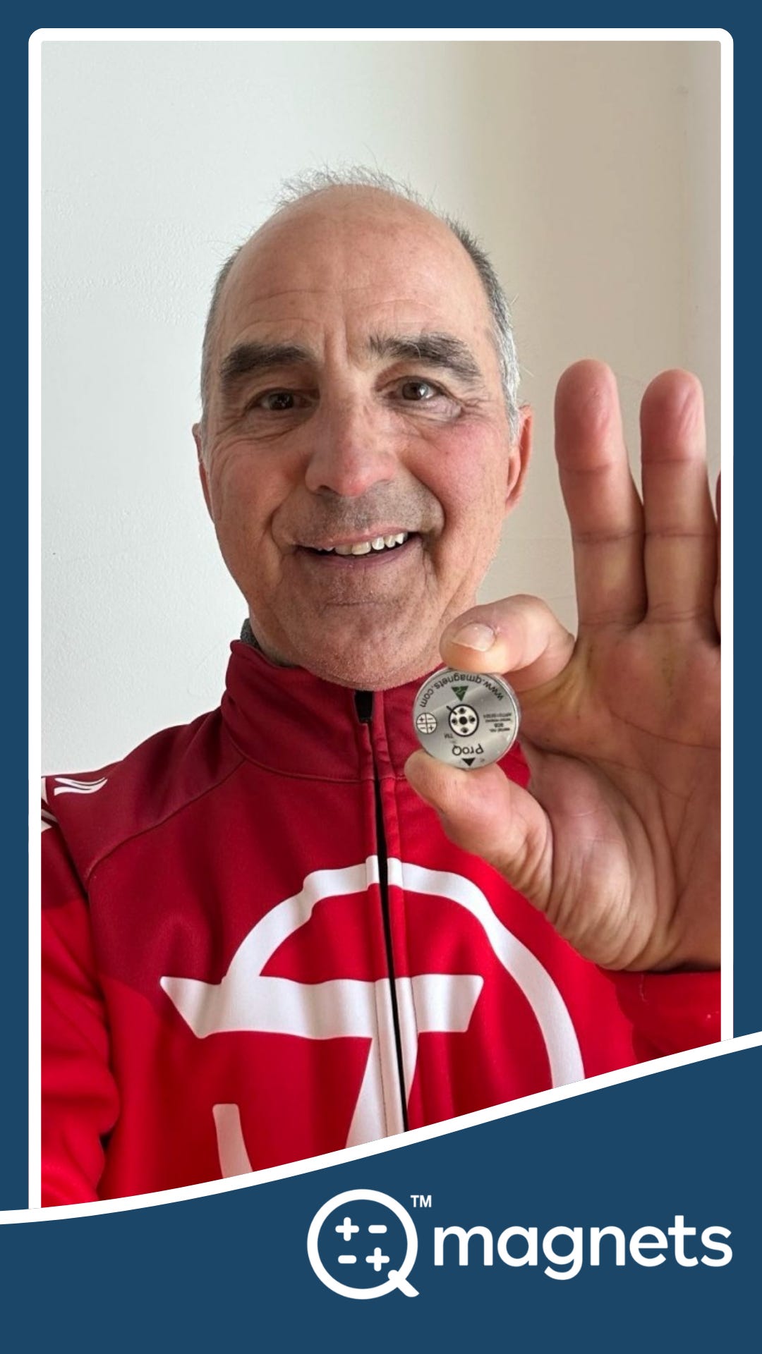 Silvano Meli holding a Q Magnet used for magnetic therapy.