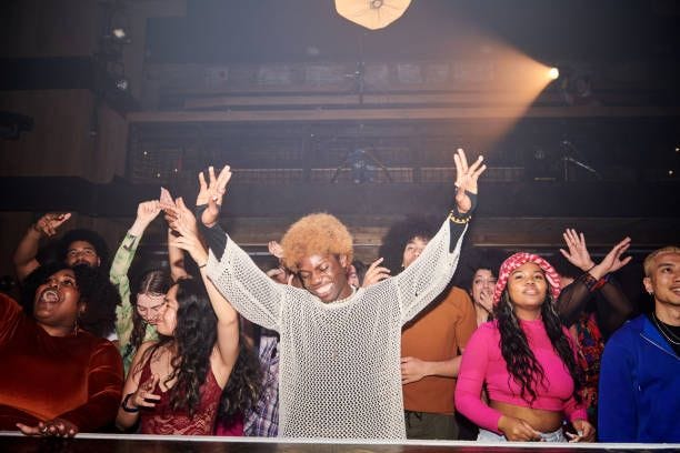 group of people dancing at a music venue. - nightclub stock pictures, royalty-free photos & images
