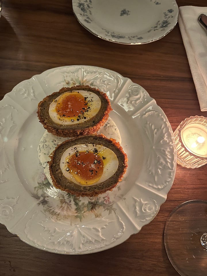 On left, two scotch eggs on a plate and on the right, a ginger pudding with a dollop of vanilla ice cream on top.