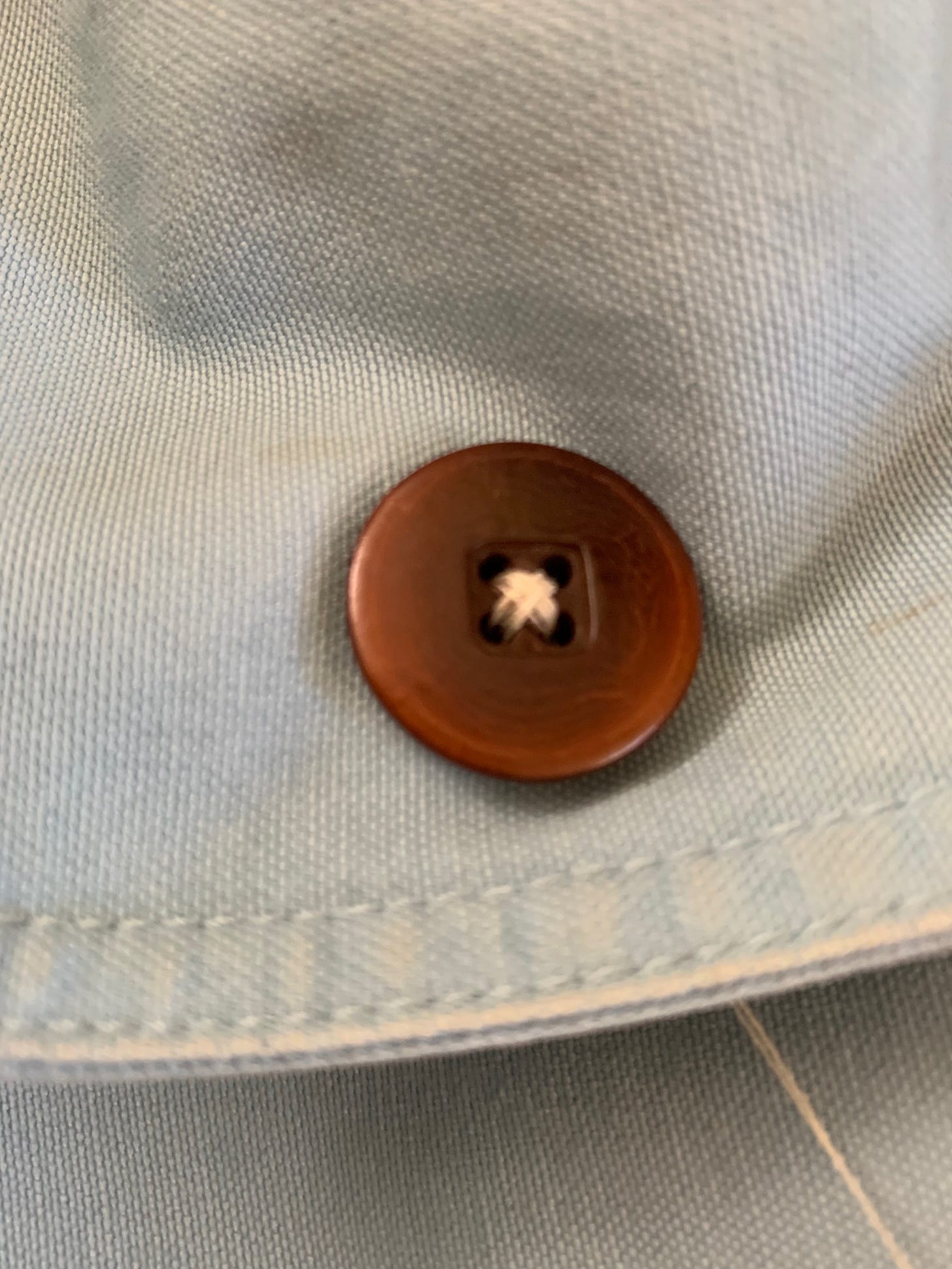 stitched button with white thread