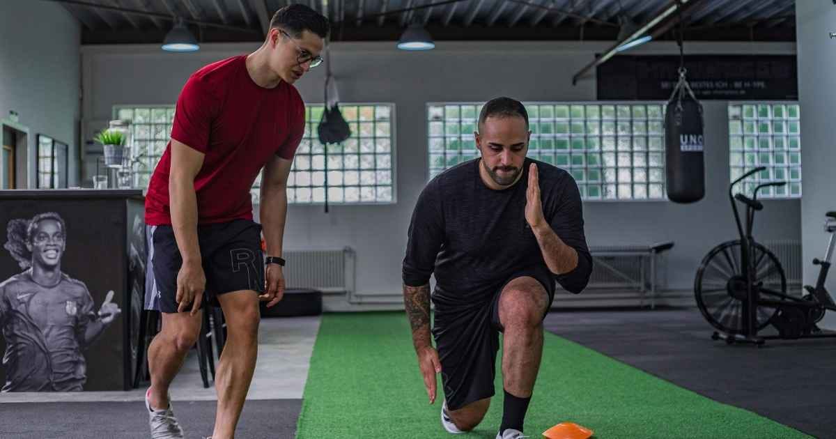 Man doing walking lunges with instructor