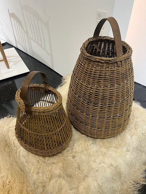 1. Zena Holloway -- Rootfull samples on the wall; 2. Nic Webb scorched wood lamp; 3. Scarlett Farrer sheepskin rug, with Studio Amos willow baskets.
