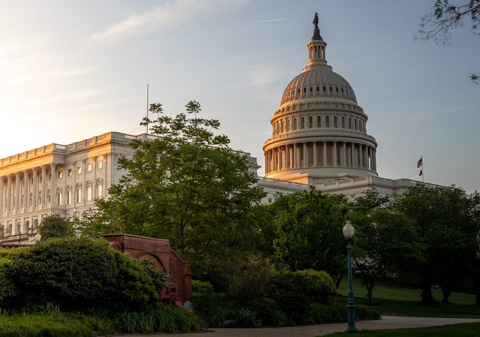brown concrete building near green trees during daytime