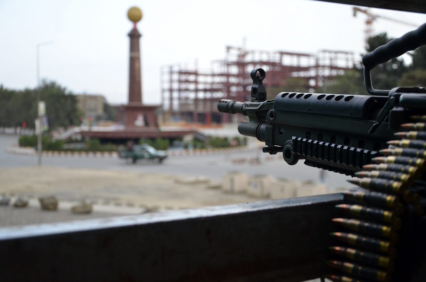 An American machine gubn points at a truck in a traffic circle in Kabul in 2011.