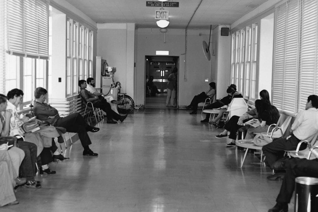 On the Lookout for God: people in a hallway waiting room sitting on chairs