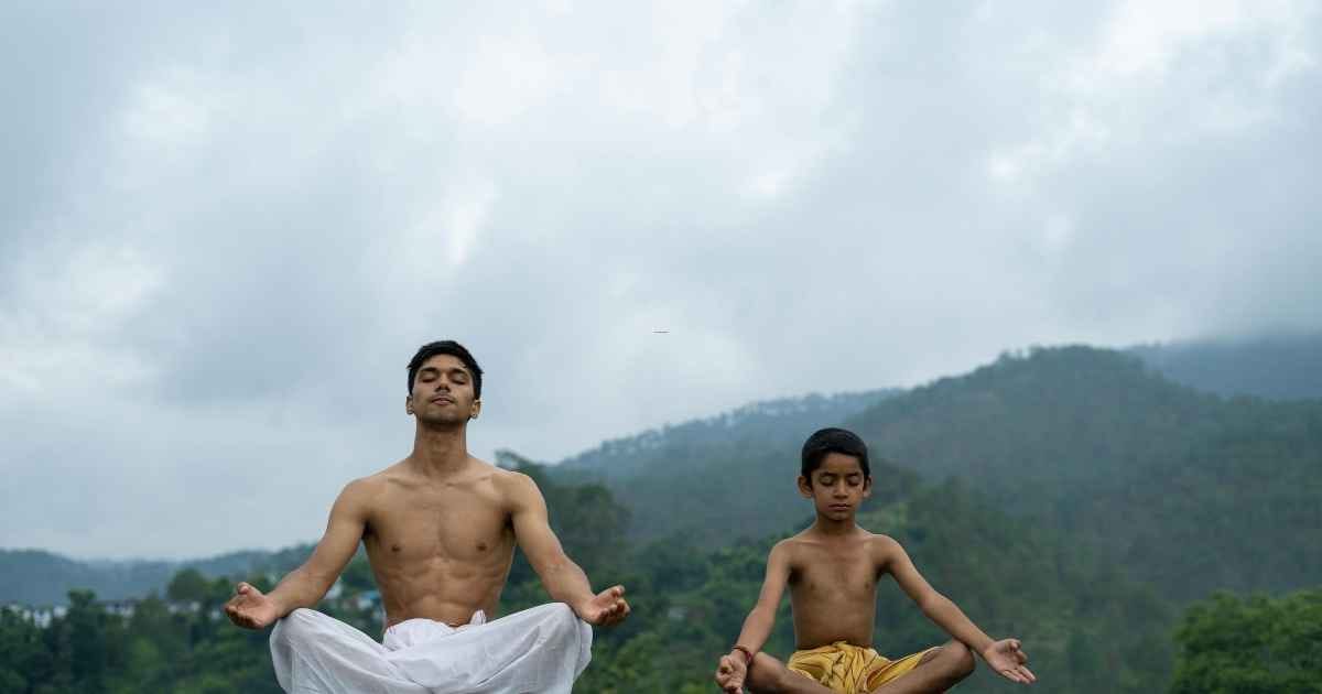 A Man Meditating with a Boy