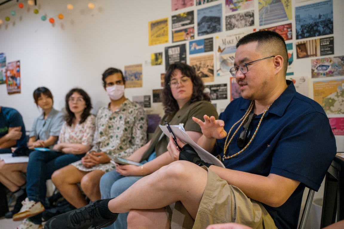 Photo of Han-Ling facilitating a round table group discussion during Short Stories club number 14.