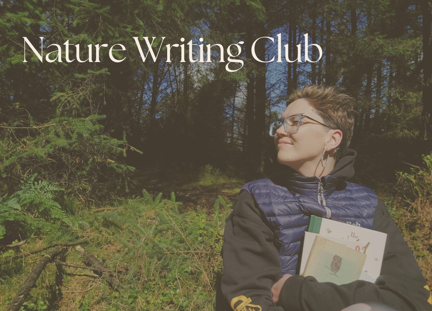 Janelle in the wild! I am sat in a lush wooded area holding books and looking over to one side looking content. The sun is shining. Text reads Nature Writing Club