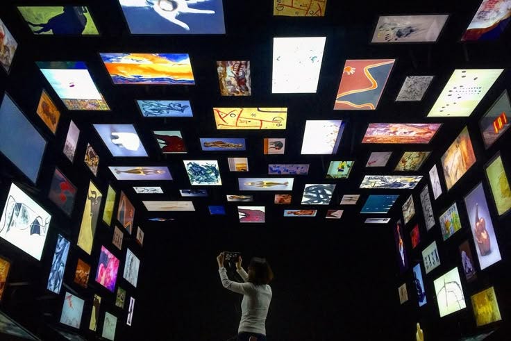 This may contain: a woman standing in the middle of a room filled with pictures