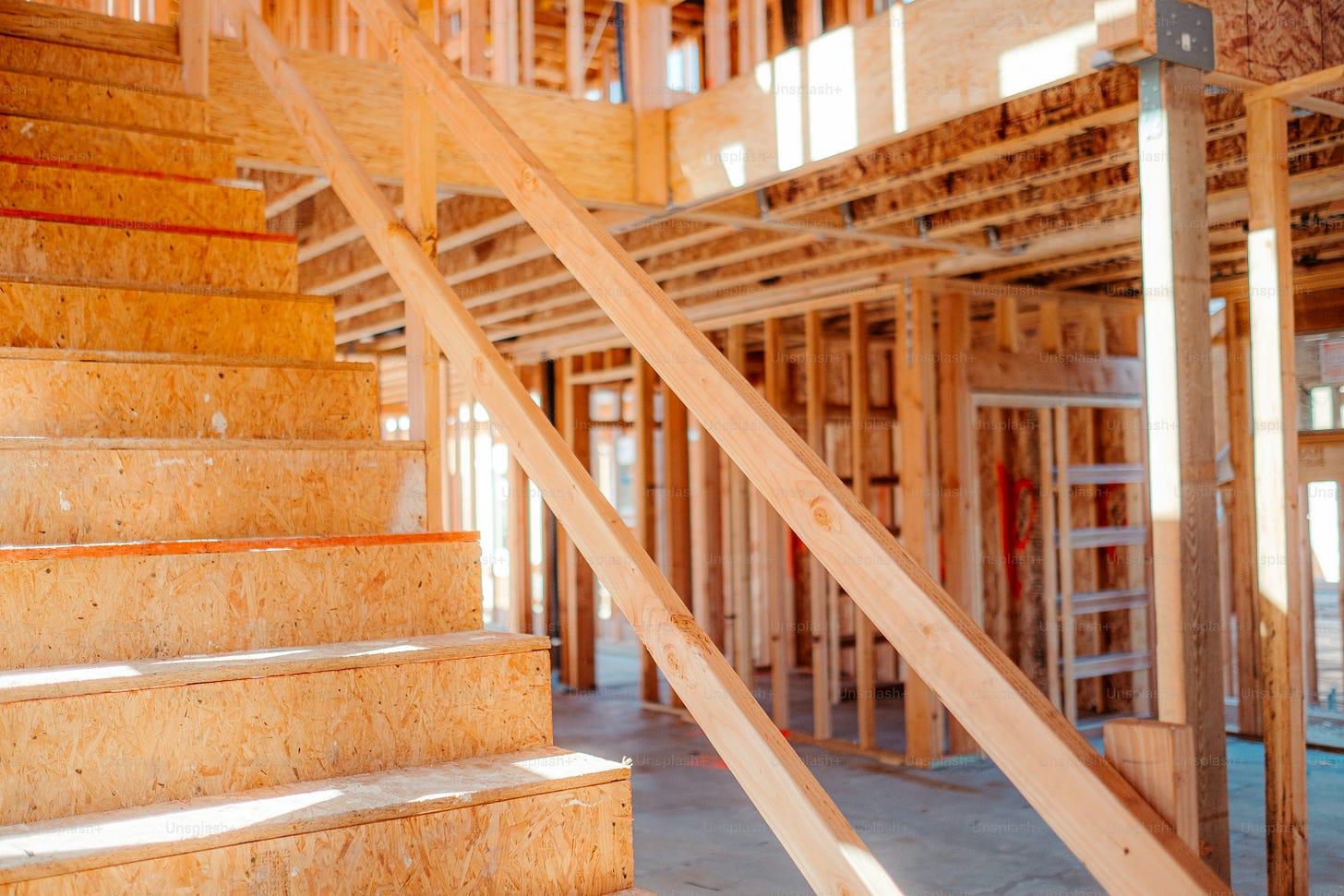 a house under construction with wooden stairs a house under construction with wooden stairs