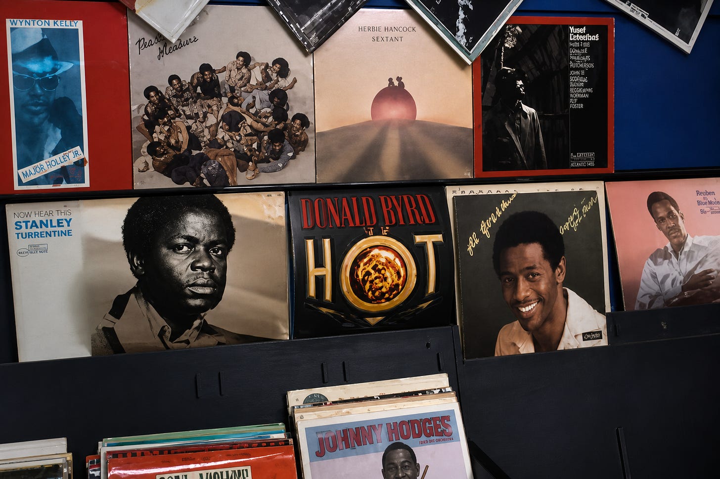 A record shop wall stacked with soul, jazz, and reggae releases reflects the soundscape of the Black diaspora, where music stores doubled as cultural hubs and community meeting points.