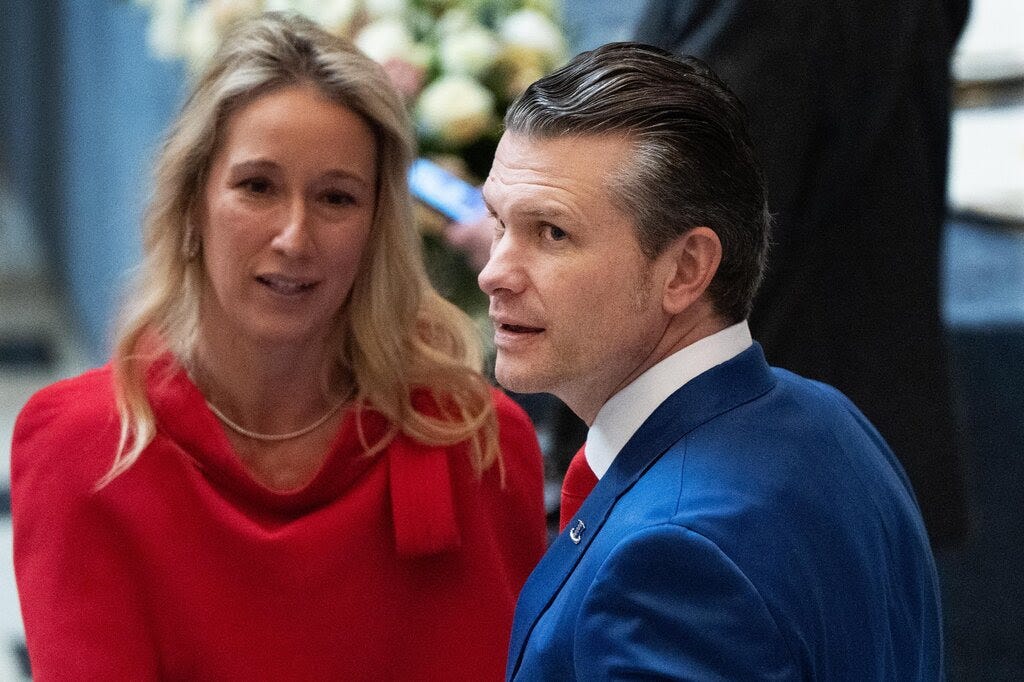 Pete Hegseth, in a blue suit, and Jennifer Rauchet in a red top.