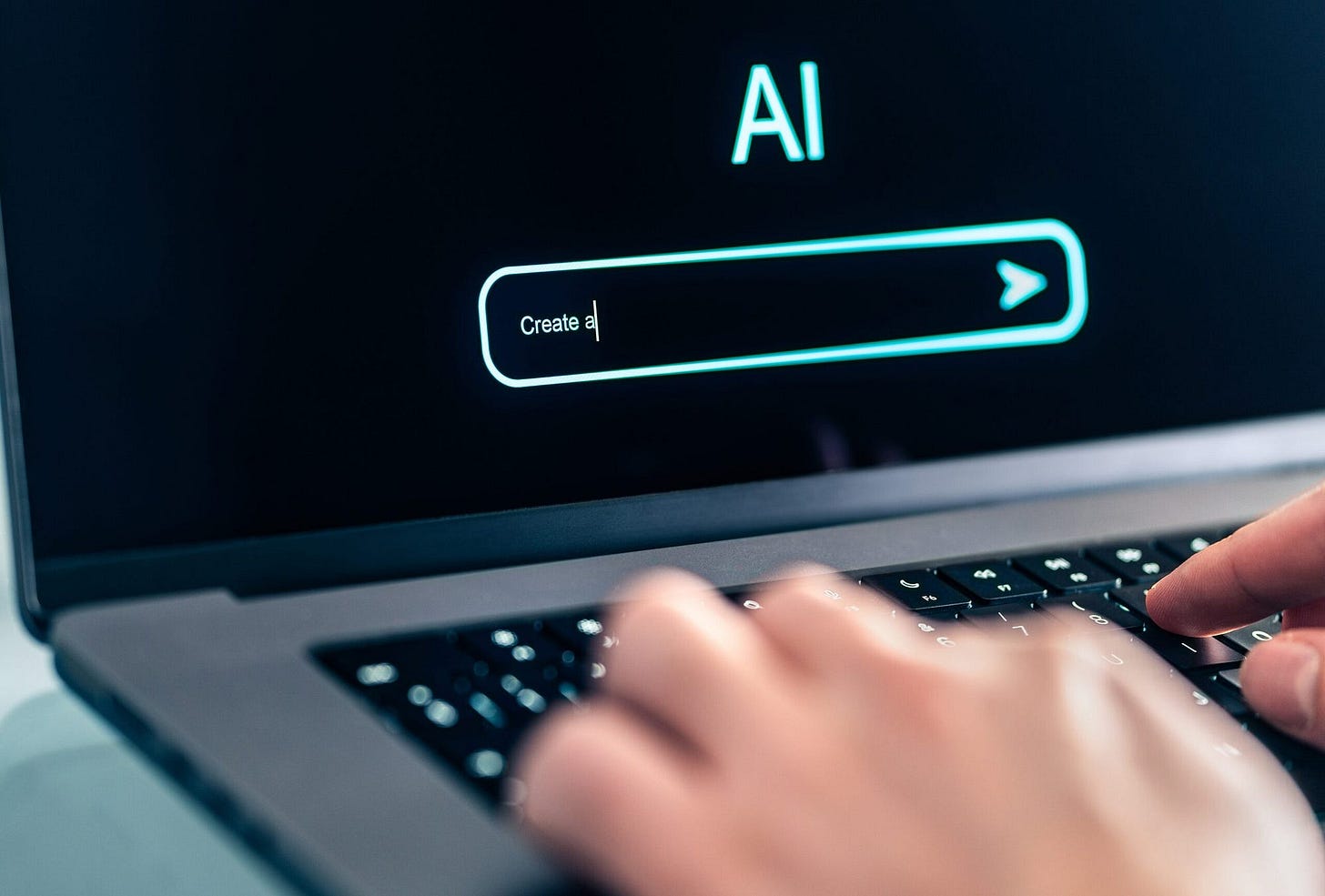 Close-up of hands typing on a laptop keyboard with a screen displaying the word “AI” and a search bar. The focus suggests a technology theme.