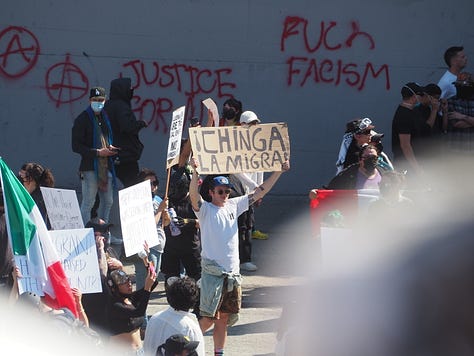 Protesters and California Highway Patrol officers facing each other on the 101 freeway in Los Angeles.