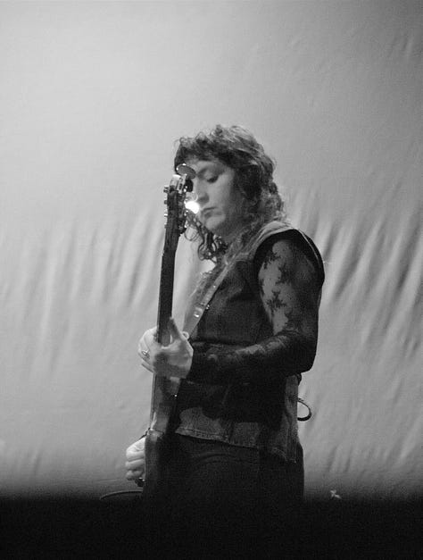 Black-and-white photos of each member of the Tweedy band performing live