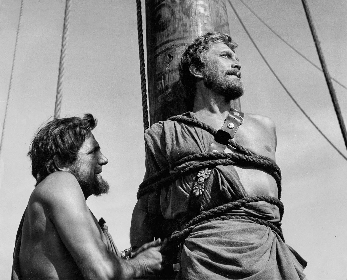 A person tied to the mast of a ship.