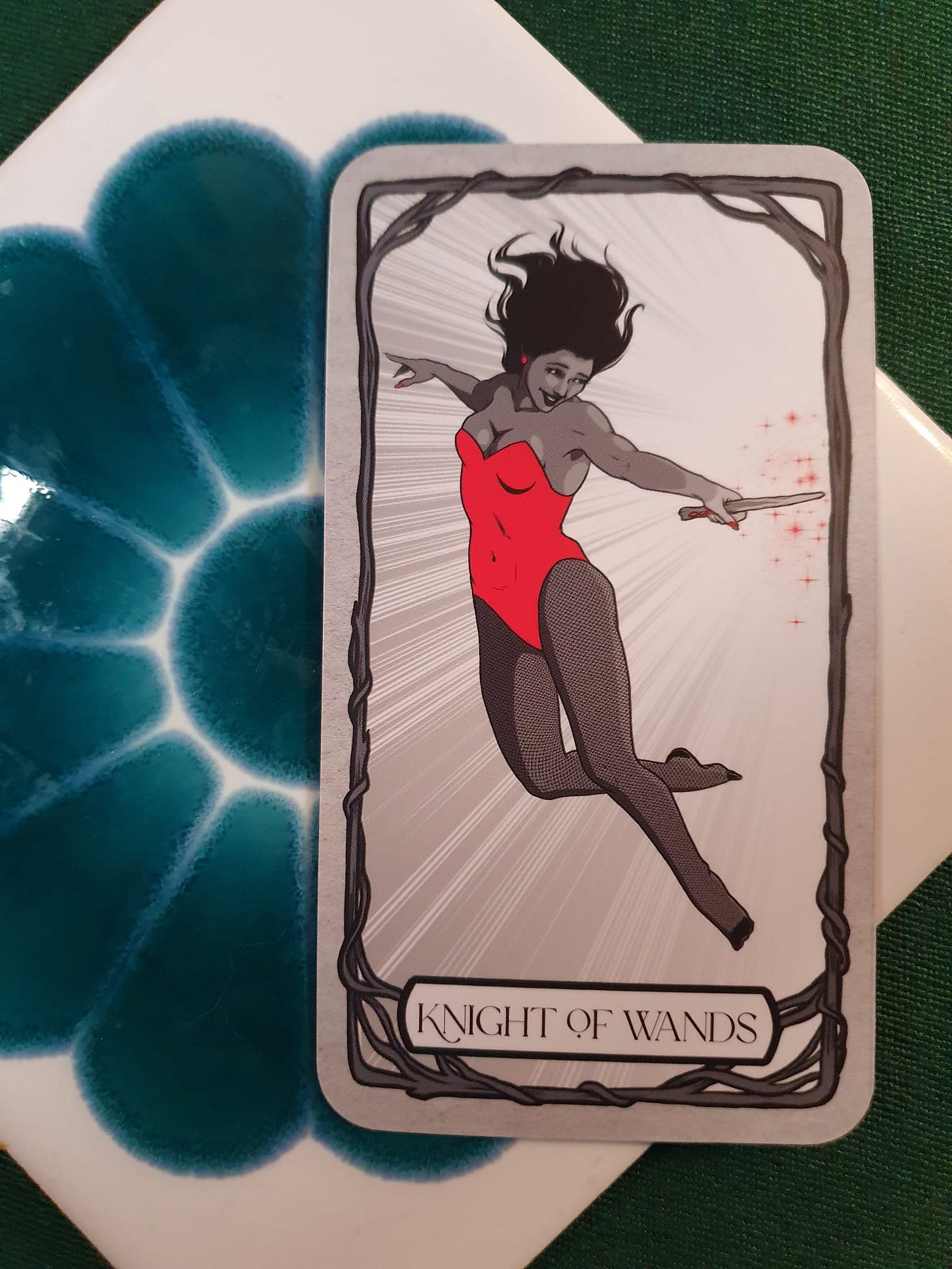 Knight of Wands tarot card from Elizabeth Sulis Kim’s Tarot DMs reading, depicting a leaping figure in red holding a wand. Knight of Wands tarot card from Elizabeth Sulis Kim’s Tarot DMs reading, depicting a leaping figure in red holding a wand.