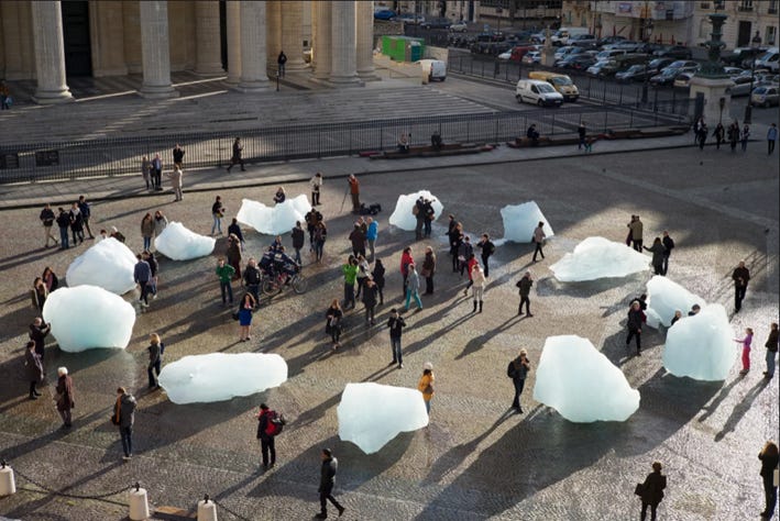 A group of people standing around ice blocks

AI-generated content may be incorrect.