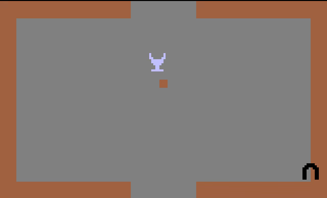 We see a blocky low res goblet. This is the magical chalice, the ultimate prize in the Atari 2600 game Adventure. It’s being carried by the player avatar, which is to say that the chalice is adjacent to a monochromatic square. The round black horseshoe magnet is also visible. This is used in the game to fish objects out from walls when the thieving bat sticks them there. We see a blocky low res goblet. This is the magical chalice, the ultimate prize in the Atari 2600 game Adventure. It’s being carried by the player avatar, which is to say that the chalice is adjacent to a monochromatic square. The round black horseshoe magnet is also visible. This is used in the game to fish objects out from walls when the thieving bat sticks them there.