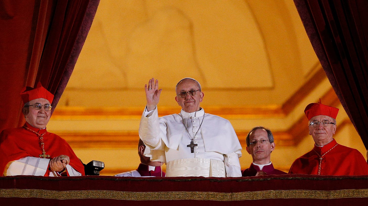 Pope Francis waving at his election in 2013.