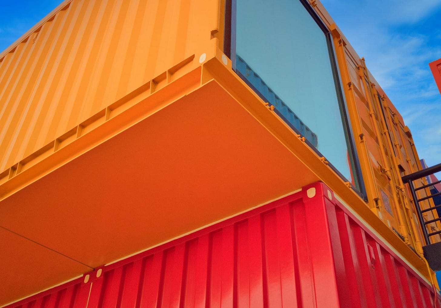 yellow and red wooden building under blue sky during daytime yellow and red wooden building under blue sky during daytime