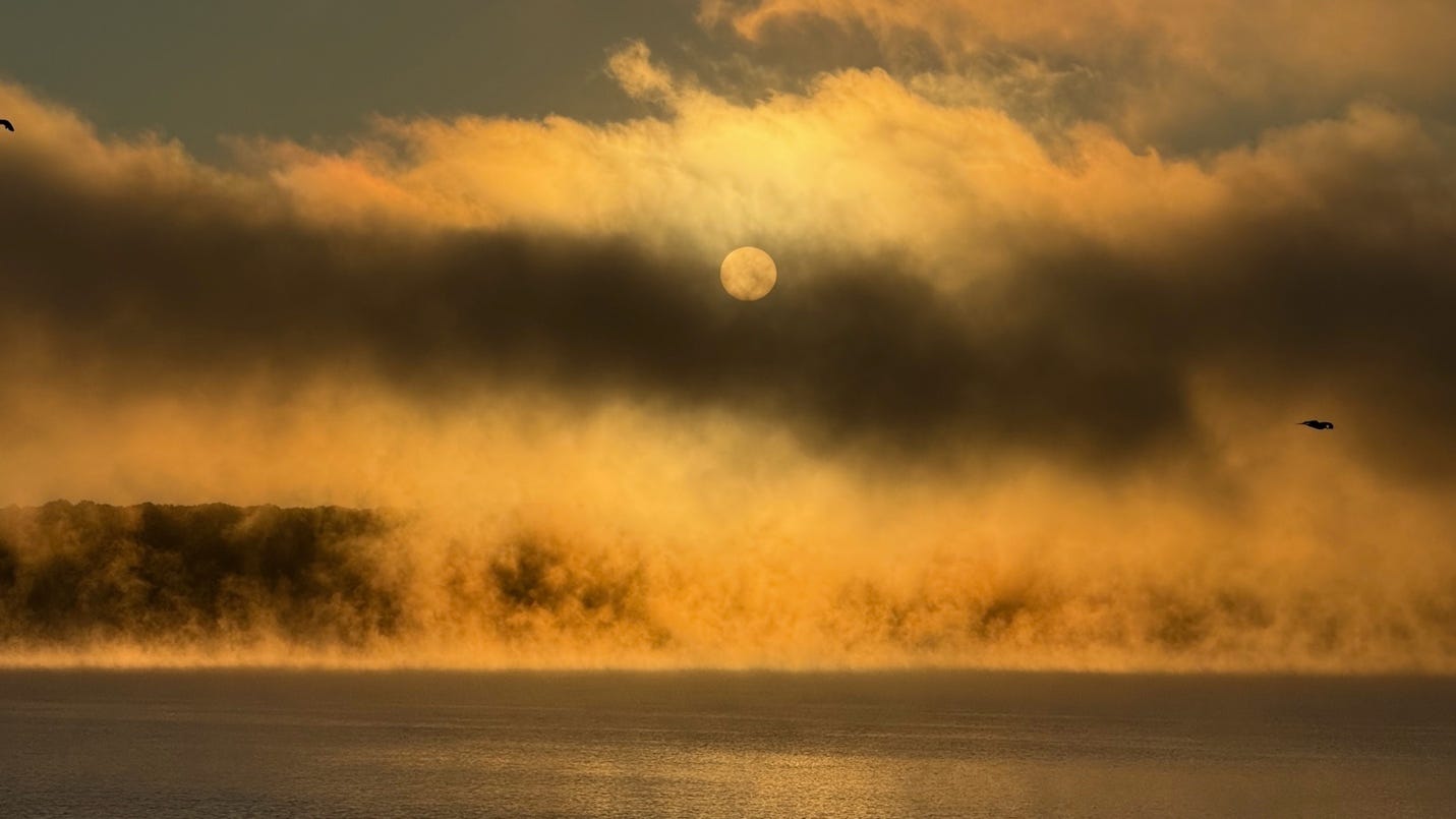 A sun rising over a body of water

AI-generated content may be incorrect.