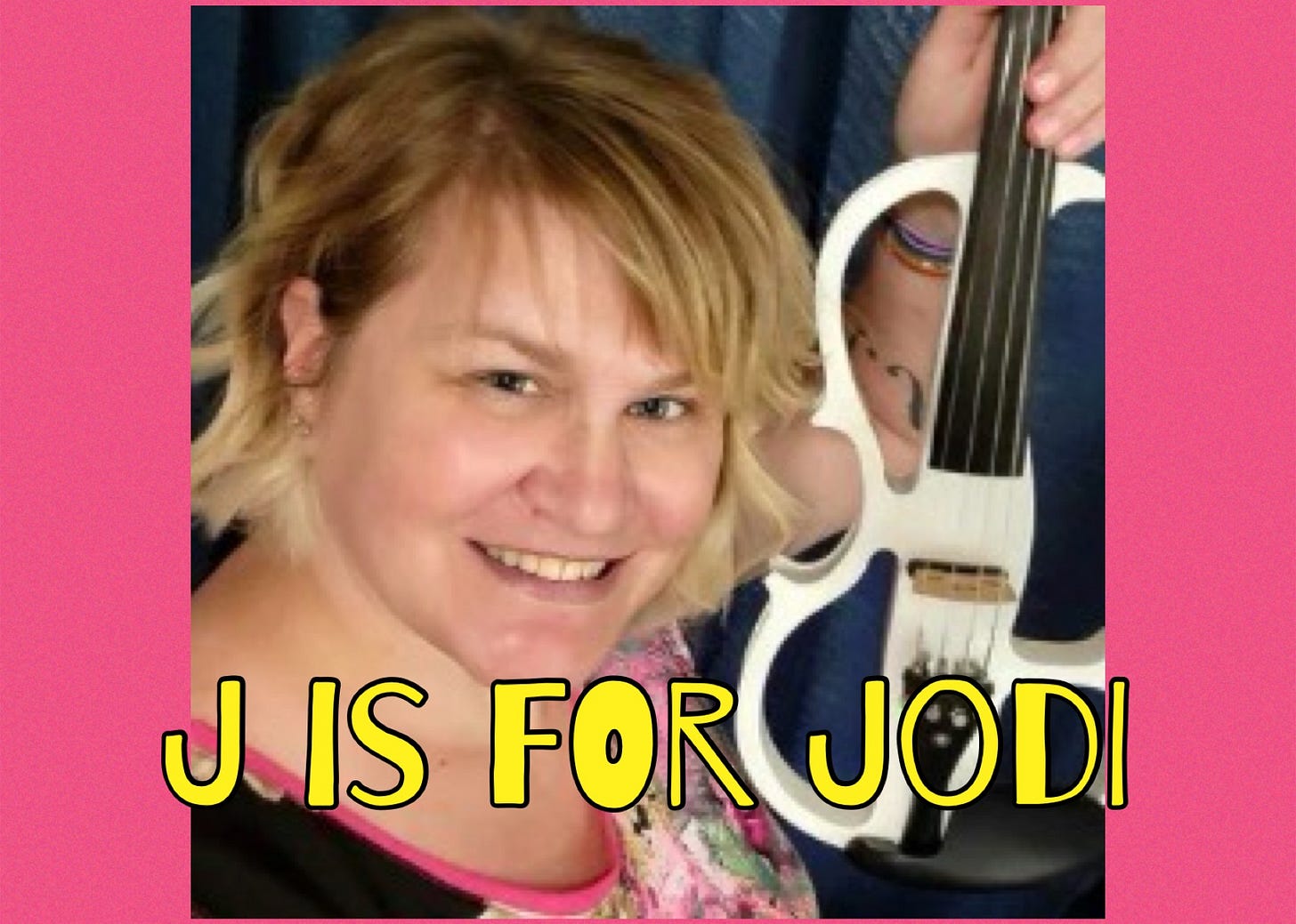 A photo of Jodi holding her white, electric violin. Jodi has shoulder-length blonde hair and is smiling & looking at the camera. 