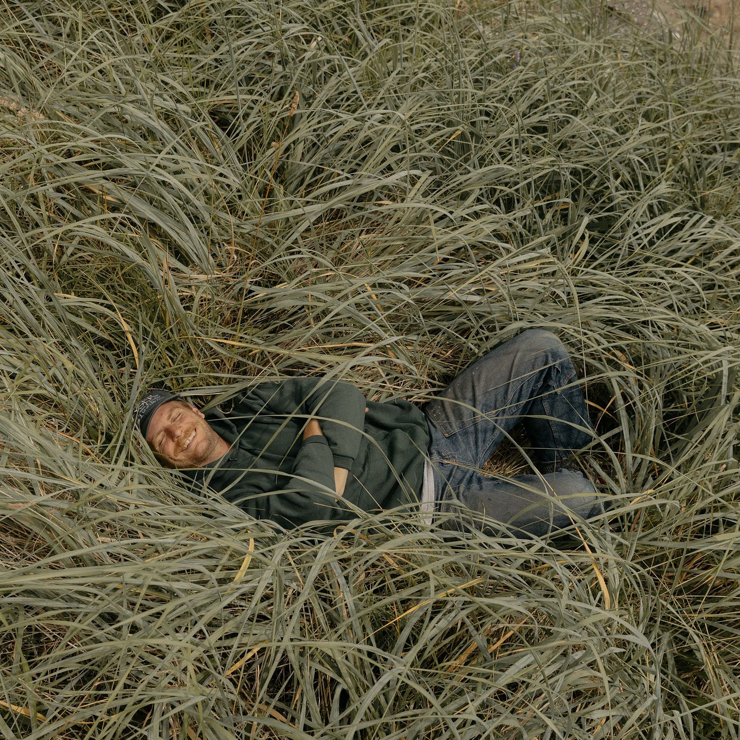 A man lying in grass.
