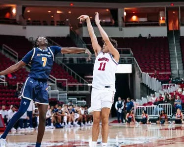 Jac Mani shooting a three