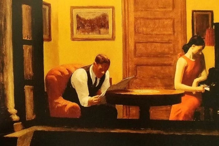 A man and woman share a room while ignoring one another