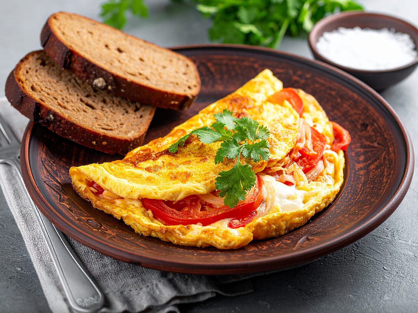 An egg-white bhurji (spiced scramble) on a plate with rye bread.