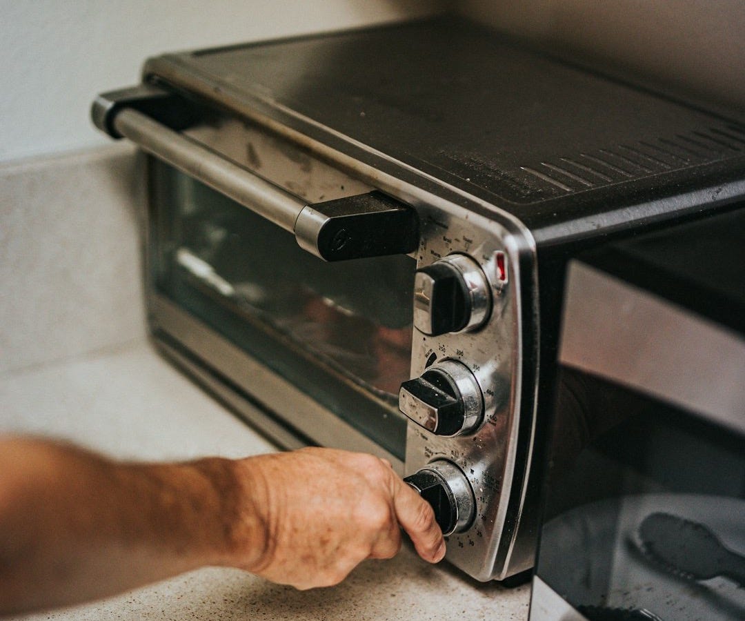 person holding stainless steel gas stove