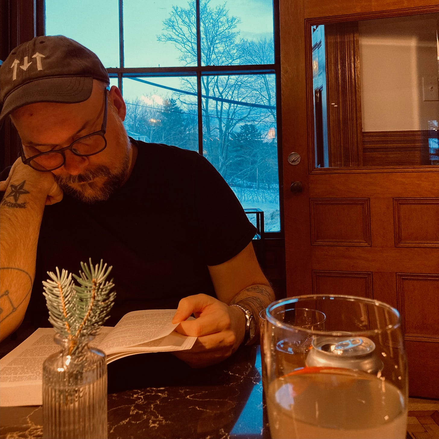 The author, reading the latest iteration of The Best American Short-Stories before a fire (unpictured), with a February snow visible outside. The author, reading the latest iteration of The Best American Short-Stories before a fire (unpictured), with a February snow visible outside.