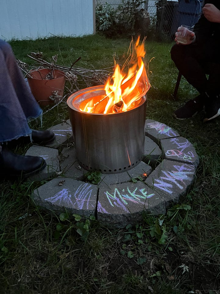 person wearing a plastic pumpkin carved into a jack-o-lantern and a photo of a fire