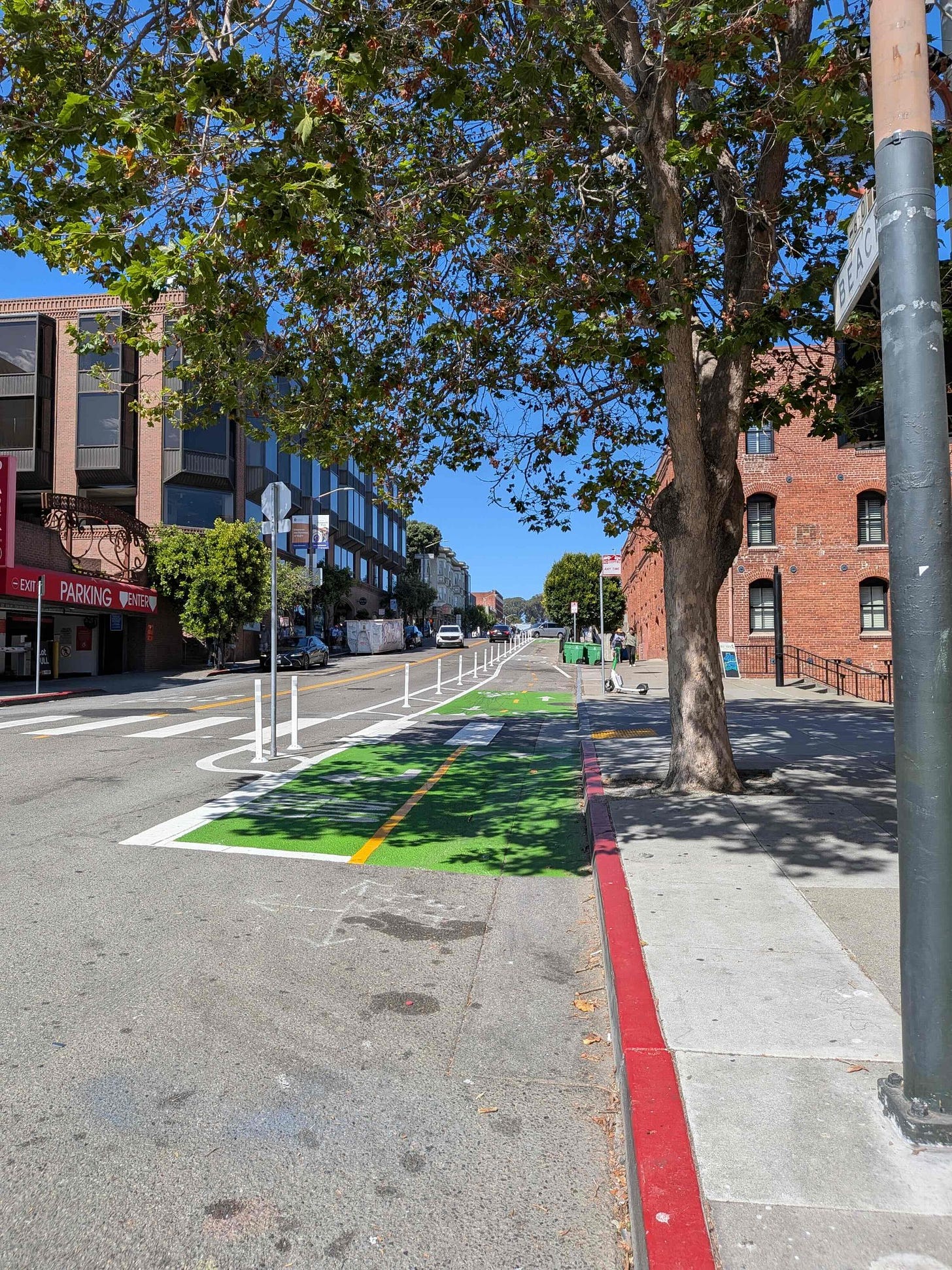 Photo shows the shaded bikeway ending. Bikeway is painted green.
