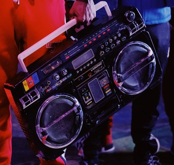 man in red jacket holding black dj controller
