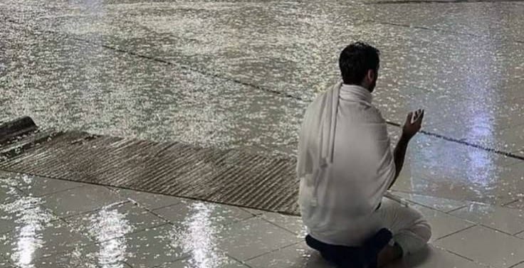 This may contain: a man kneeling on the ground in front of a building