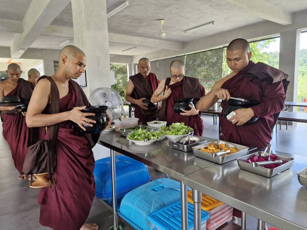 monks getting food at buffet