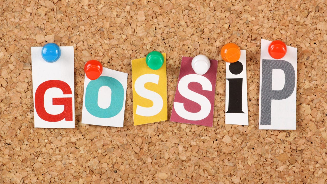 The word "Gossip" on a corkboard.