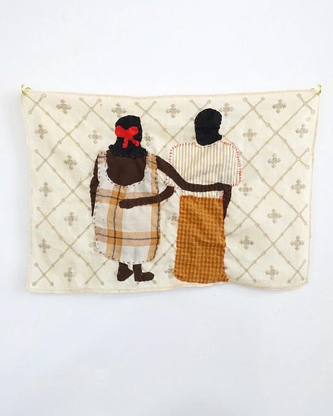 An assortment of textile art and patchwork dresses made by Sarah Nsikak.