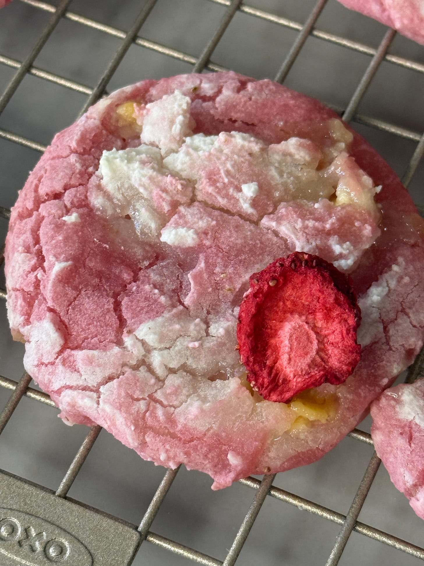 Strawberry mochi cookie on wire rack