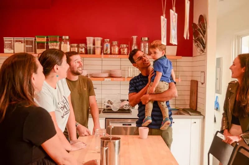 Dwellers in kitchen of communal home.