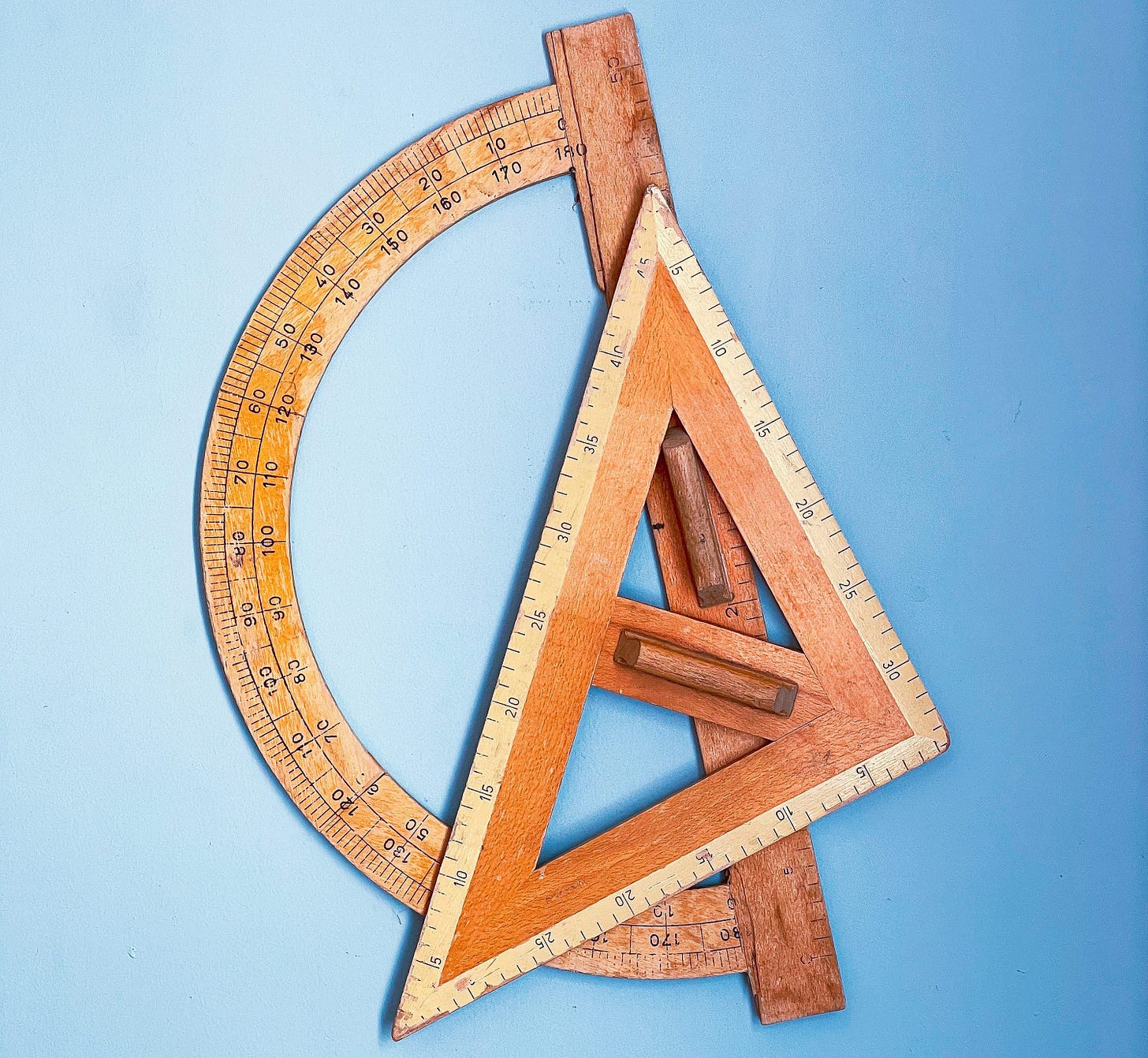 a wooden ruler and a wooden triangle on a blue background a wooden ruler and a wooden triangle on a blue background