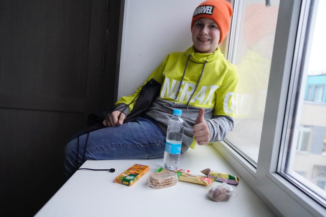 A person sitting at a table with food and a water bottle

Description automatically generated with medium confidence