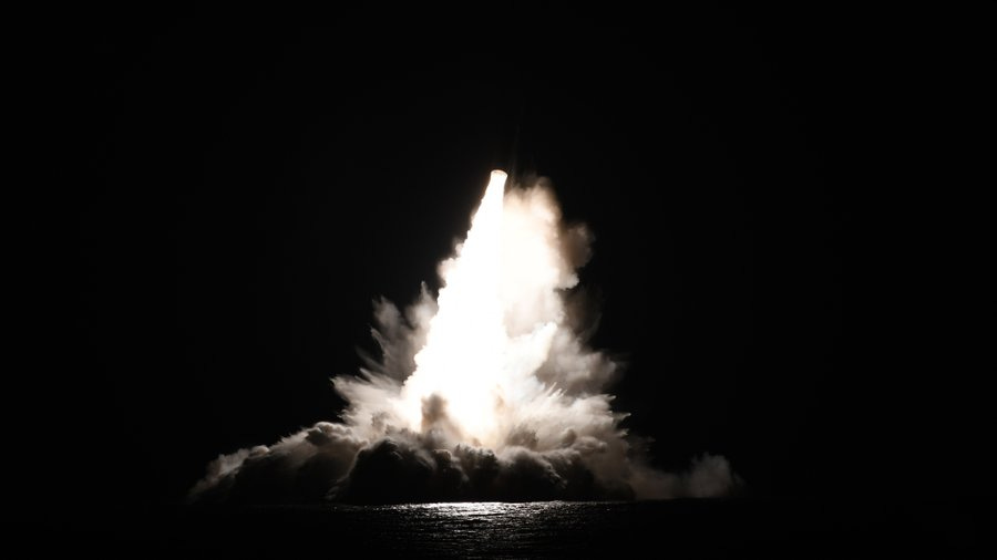 A bright plume of light and smoke rising from the ocean at night, created by the launch of a Trident II D5 missile from an Ohio-class ballistic missile submarine. A bright plume of light and smoke rising from the ocean at night, created by the launch of a Trident II D5 missile from an Ohio-class ballistic missile submarine.
