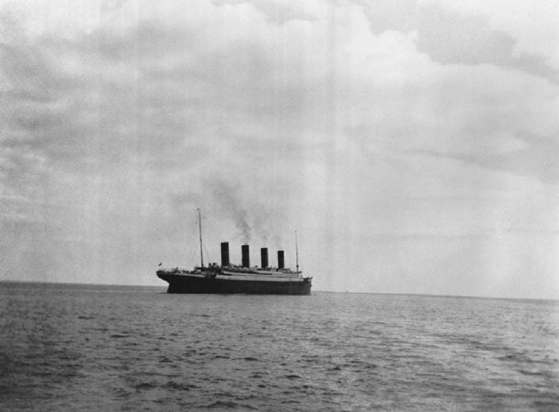 April 11, 1912: The magnificent RMS Titanic departs the Irish coast near Queenstown (now Cobh), captured in one of the last known photographs before its fateful sinking.