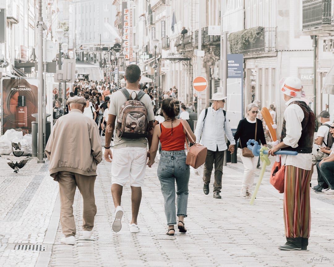 People of different generations walking down a Porto street People of different generations walking down a Porto street