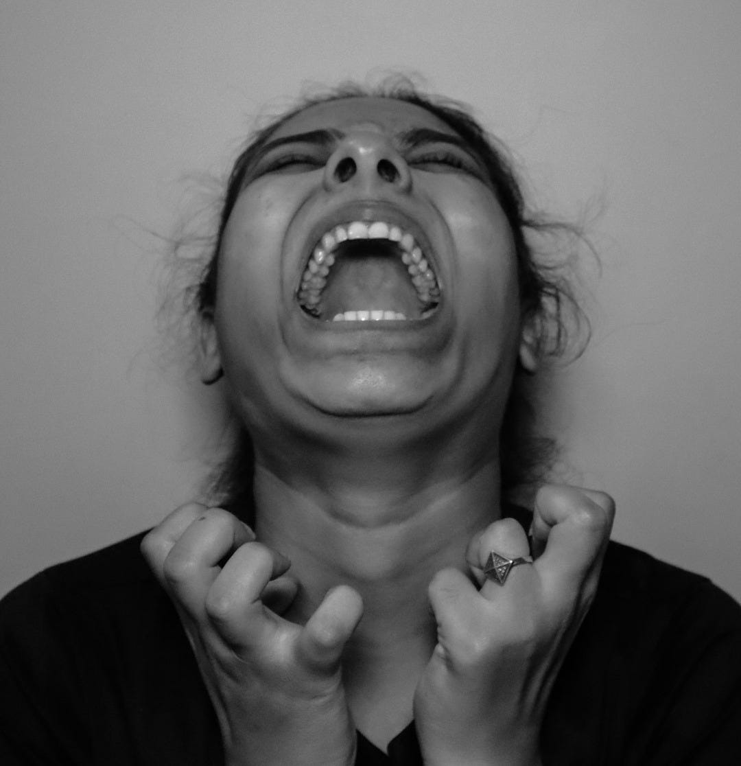 a woman with her mouth open and hands in front of her face a woman with her mouth open and hands in front of her face